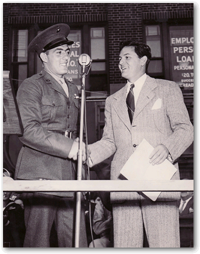 John Basilone on podium with actor John Garfield.